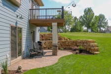 tiered flagstone retaining walls and a patio