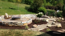 Above ground raised fire pit with garden and retaining wall